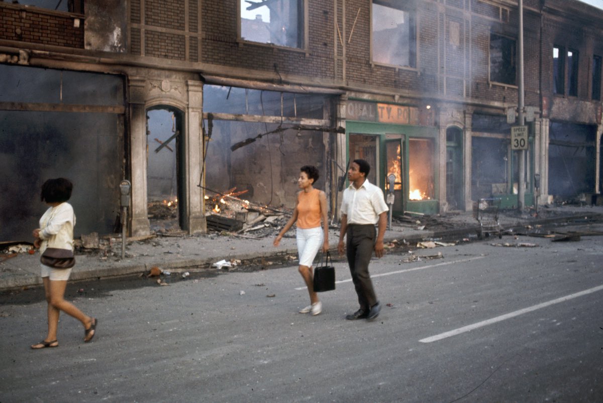 Subject: African Americans stroll the burning streets of Detroit during the race riots.  Detroit, Michigan 1967 Photographer- Howard Bingham Time inc NOT owned Merlin-1153219