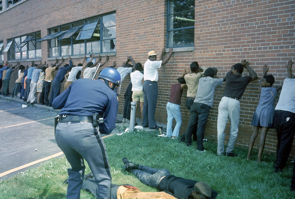 MICHIGAN, UNITED STATES - 1967:  Policeman lining up suspects after race riots.  (Photo by Declan Haun/The LIFE Picture Collection/Getty Images)