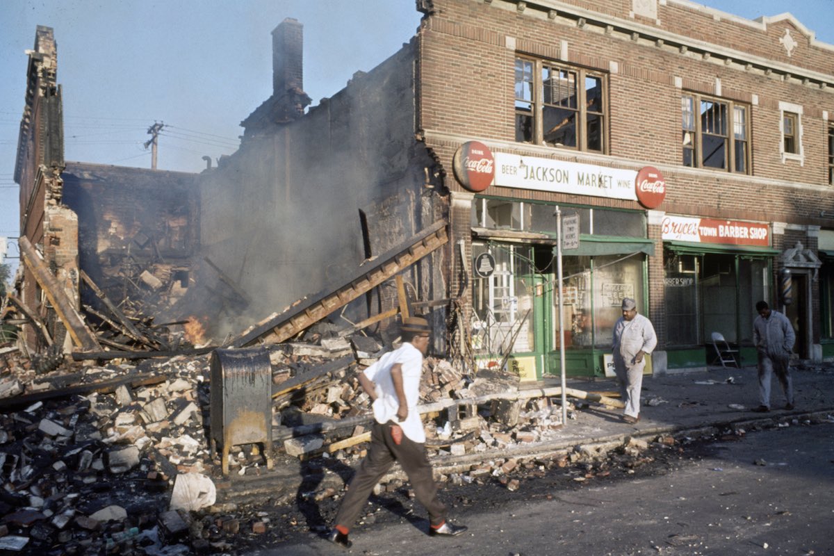 Subject: People walk by destroyed and burned out building caused by the Race Riots in Detroit, Michigan July 1967 Photographer- Lee Balterman Time Inc Owned Merlin-1153578