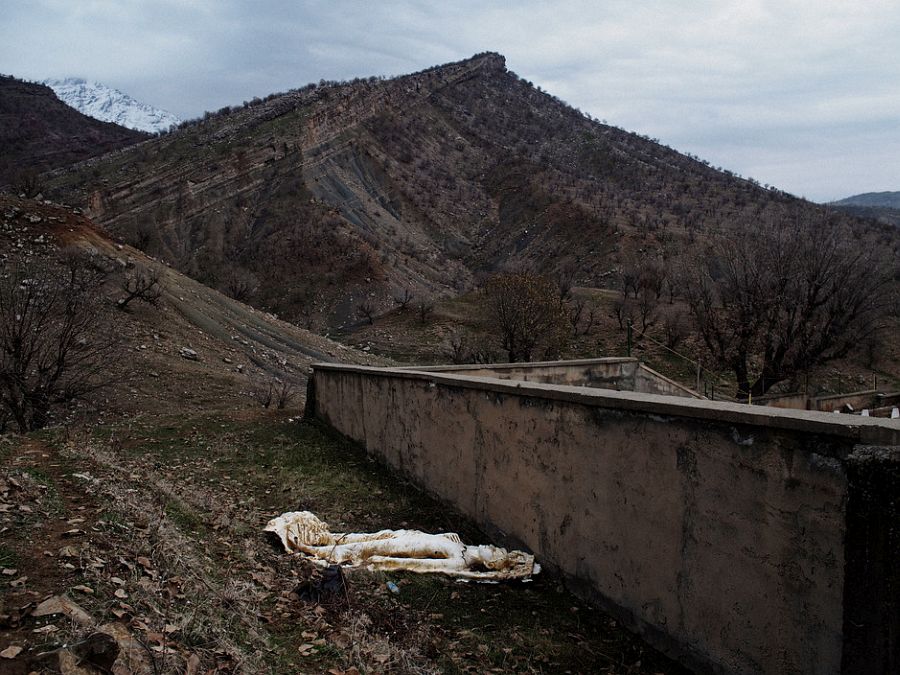IRAQ. Kurdistan. December 1, 2014. A monument erected in honor of fallen PKK fighters overlooks the Qandil Mountains in Iraqi Kurdistan. In the 1990s, during some of the deadliest years of the PKK-Turkey conflict, the PKK set up bases across the rugged Qandil Mountains in Iraqi Kurdistan,near the border of Iran. Since then, Turkey has periodically carried out air strikes in Qandil, aiming to hit the thousands of fighters who train and live in the moutain. But the PKK fighters in Qandil operate in various pockets of the mountain, and often live in caves, making it near impossible for Turkish jets to precisely target them. On several occasions, Turkish jets accidentally hit Iraqi Kurdish villagers living in the area instead. This prompted tensions between the the regional Iraqi Kurdish government and Turkey. In recent years, Turkey and the PKK have embarked on a fragile peace process, which has spared Qandil some of the heavy shelling of earlier years. But events in Syria and Iraq this past summer, in particular Turkish sensitivities to the PKK's increasingly prominent role in fighting the Islamic State and PKK allegations that Turkey was at times conspiring with IS to bring about the fall of Kobani, have strained the peace process. If the process collapses, the relative calm in Qandil may break as well.