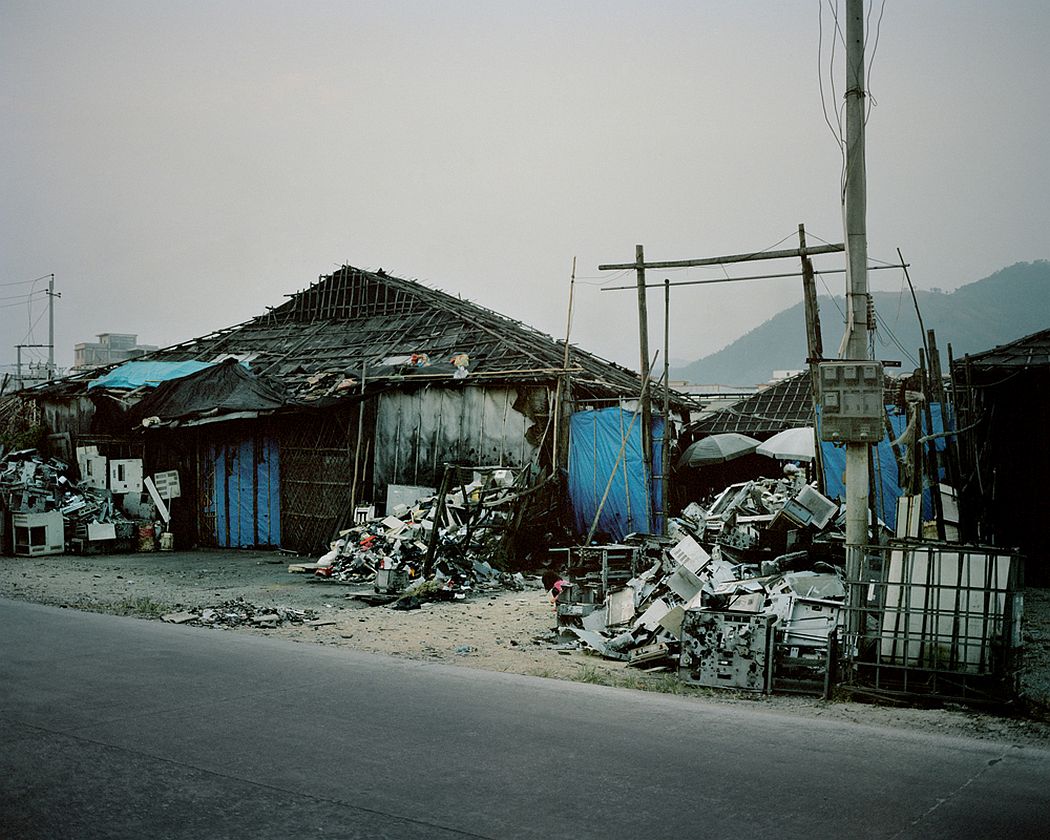Guiyu, China On the outside of a workshop where are dismantled and recycled electrical and electronic components.