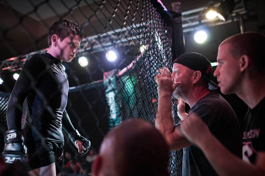 Mixed Martial Arts fighter Brock Locnikar, 8, in the octagon, takes precious advise from his corner men Clay Carpenter and Thiago Azeredo during United States Fight League(USFL) All-star Pankration show at Blue Water Casino in Parker, Arizona on 25th of October 2013. Photo: Miikka Pirinen