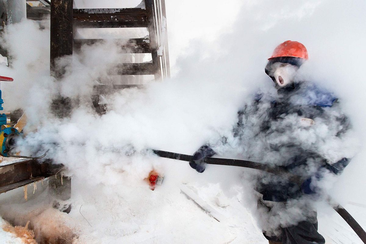 . A Russian gas worker sprays steam to unfreeze pipes in Novy Urengoi, Arctic Siberia, Russia, December 2014.