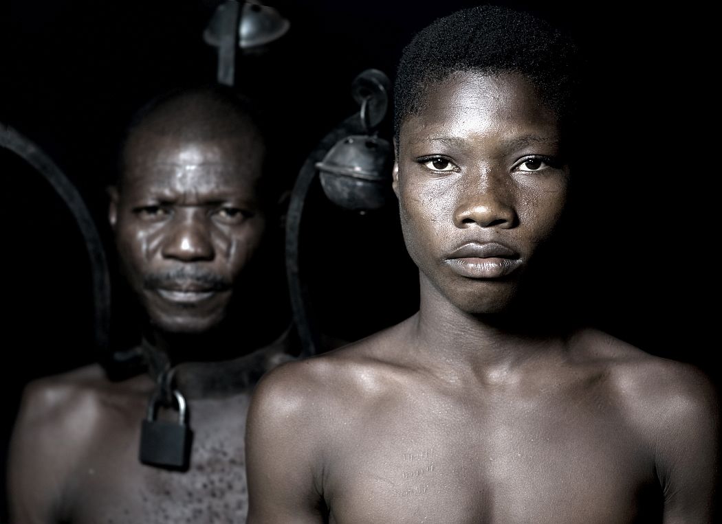 During the slave trade , fugitives were contrained to wear a bell's collar to punish and prevent them for trying to escape.With these bells collars on, they could be hear at a distance.Benin,January 2010